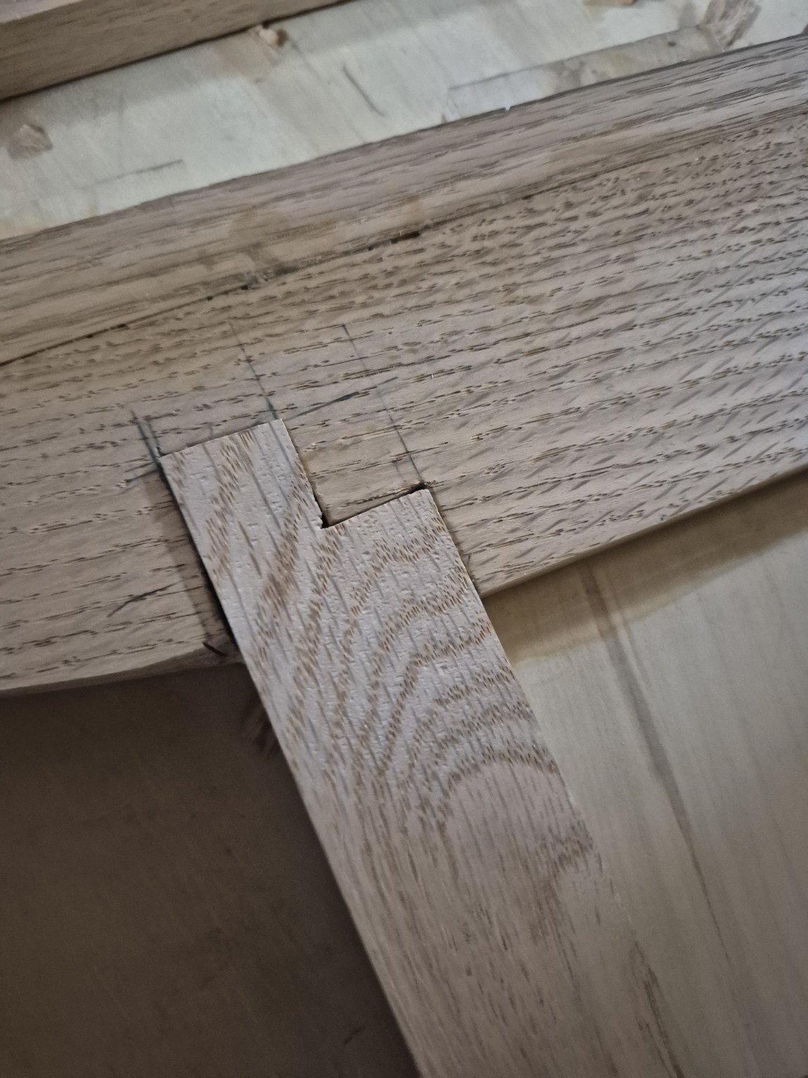Close-up of a shaped wooden connection fitted into a rail