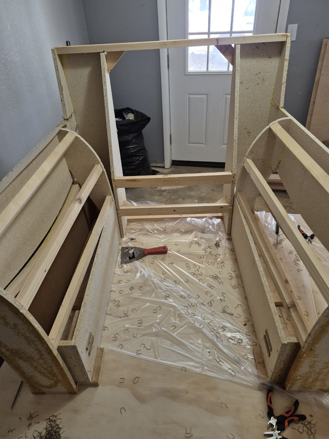 Straight-on view of the original bare frame with thin pine rails on the arms